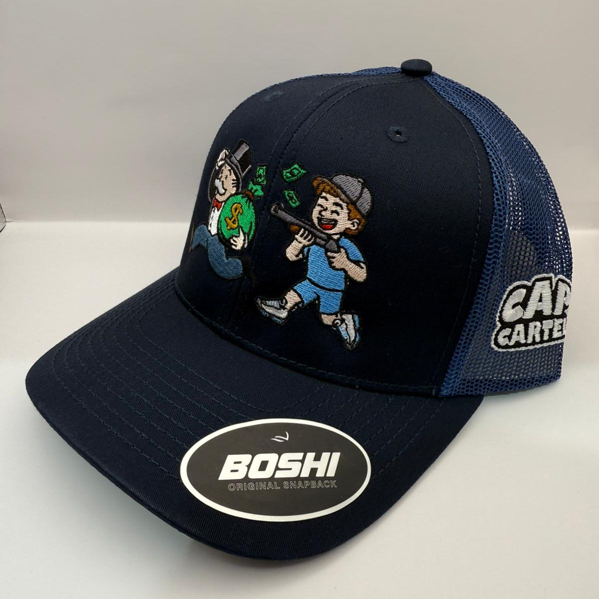Navy blue cap with cartoon characters and brand logos on a white background